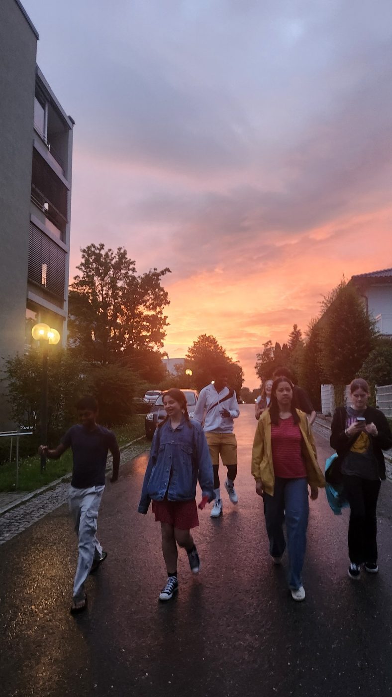 Friends walking down a street at sunset